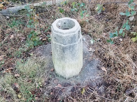 old water or drinking fountain with cement and weeds