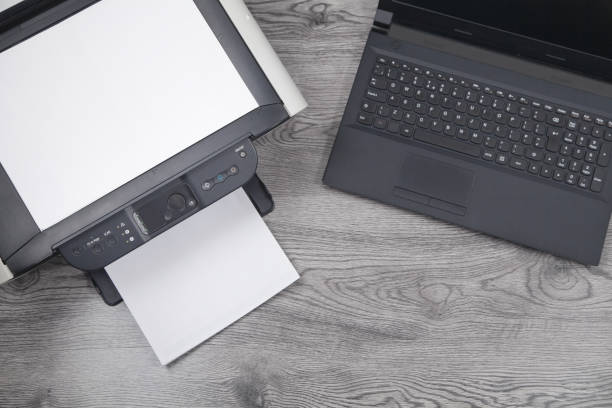 istock Xerox printer machine, laptop and papers on the desk. 1289839713