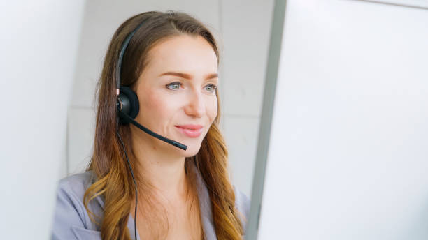 istock Business people wearing headset working in office 1289840062