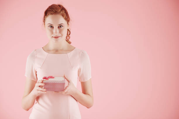 istock Young woman with giftbox 1289840484