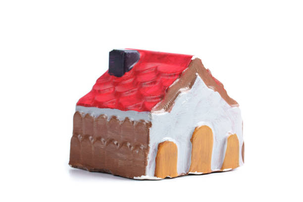 istock Handmade painted house - souvenir on white background 1289841259