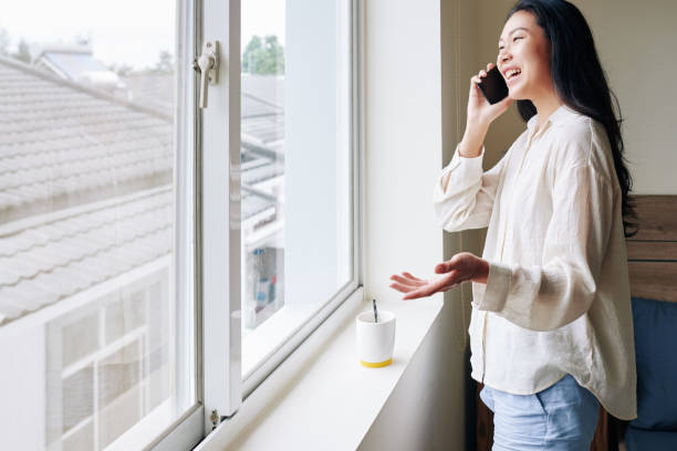 istock Laughing woman calling on phone 1289841391