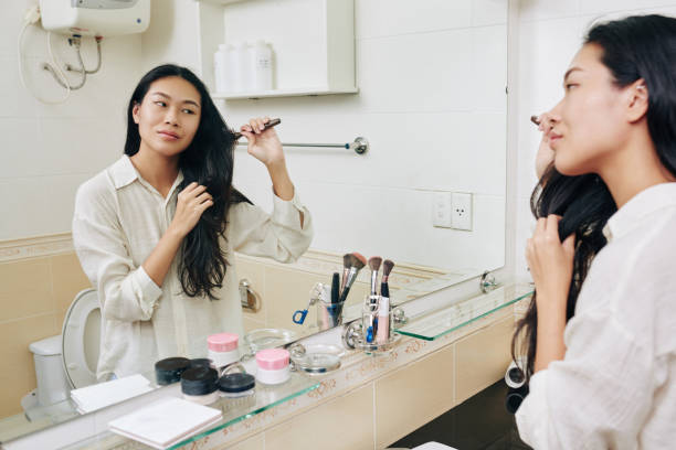istock Woman brushing hair 1289841395
