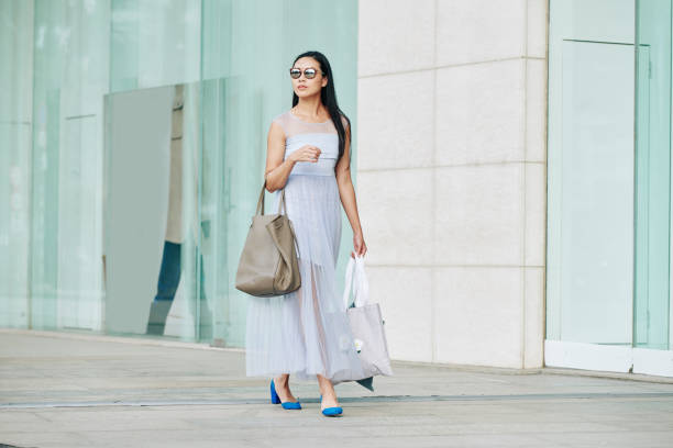 istock Woman walking down the street 1289841447