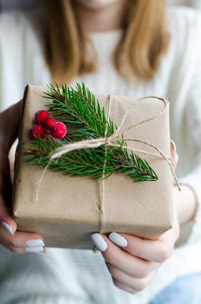 istock Woman hold Christmas or New Year decorated gift box 1289841473