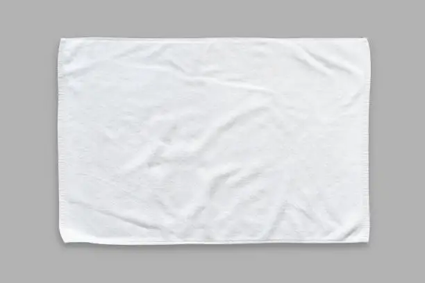 Photo of White cotton towel mock up template fabric wiper isolated on grey background with clipping path, flat lay top view