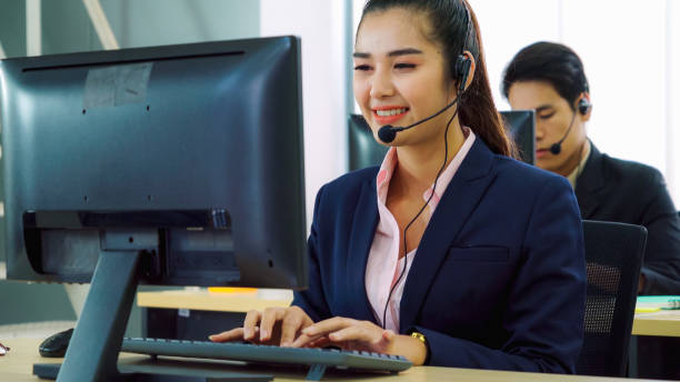 istock Business people wearing headset working in office 1289842778