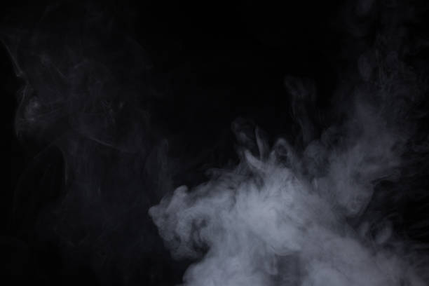istock Cloud of white smoke on a black background closeup 1289843507
