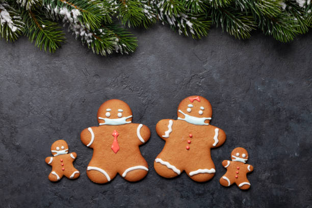 istock Greeting card with gingerbread cookies in face mask 1289843870