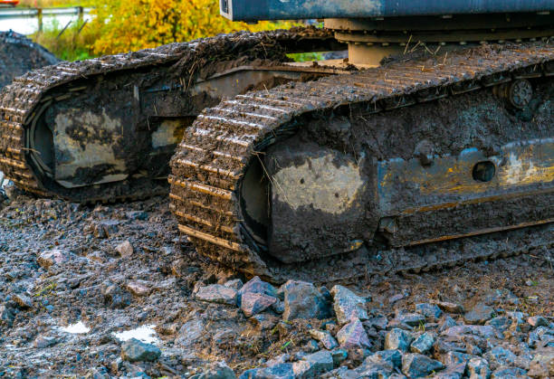 istock Iron tracks on a large excavator at a construction site. Close up. 1289843986