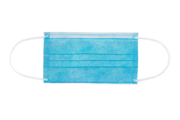 istock Blue flat medical nonwoven fabric face mask with elastic ear loops isolated on white. 1289847709