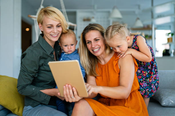 istock Happy lesbian couple playing, spending time with children at home 1289848681