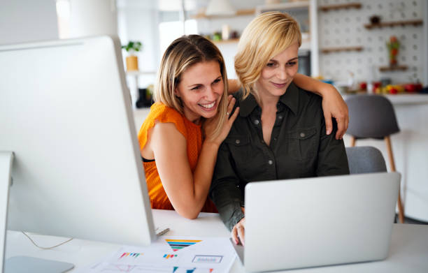 istock Happy lesbian couple planning, brainstorming at startup in office 1289848709