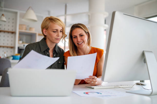 istock Business women working at the office on computer 1289848818