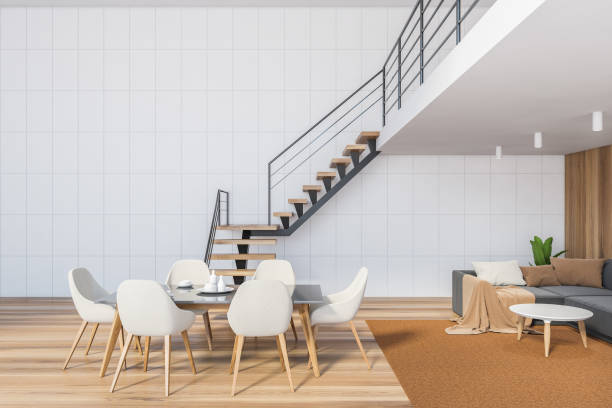 istock White living room with white chairs and table, stairs to the second floor 1289852049