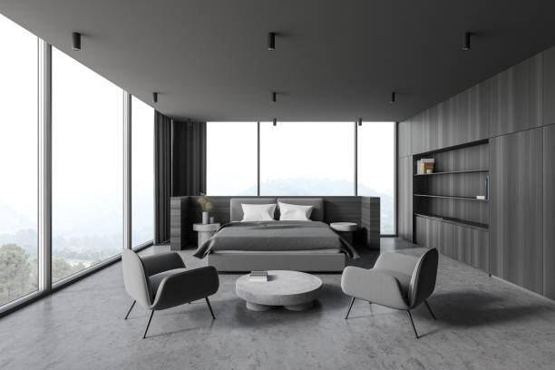 istock Modern wooden and gray master bedroom interior with armchairs 1289852615