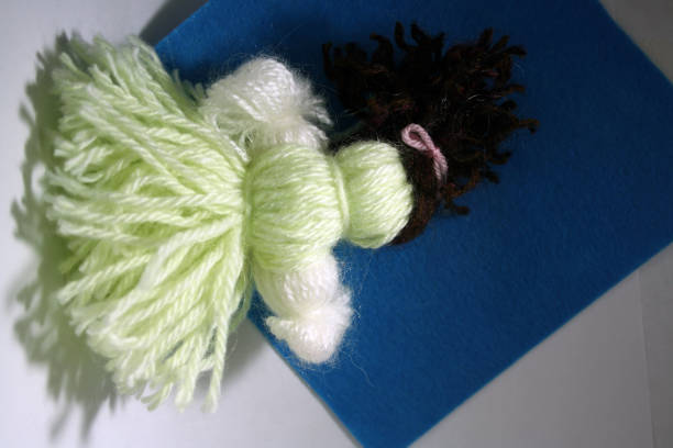 istock Toy made of threads on blue background. 1289856158