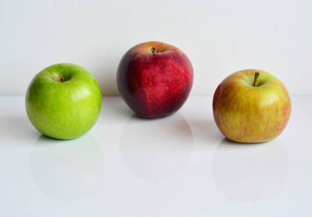 istock Red and green apples isolated on white background with reflection 1289856303