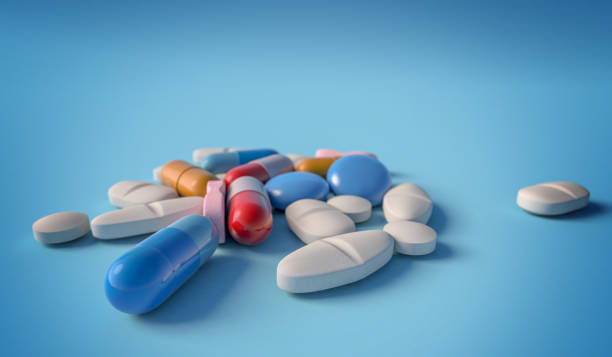 istock Medical drugs isolated on blue backdrop 1289856517