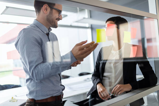 istock Business people having fun and chatting at workplace office 1289859041