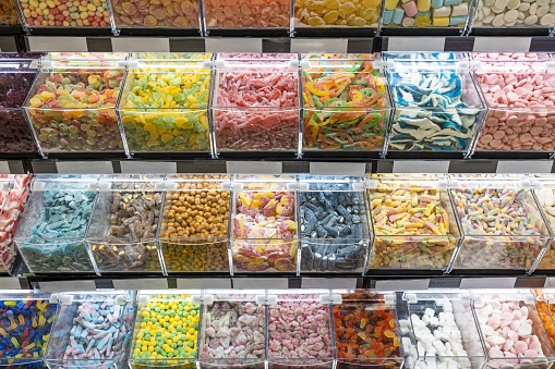 Close up view of stand of colorful candies. Unhealthy food concept.