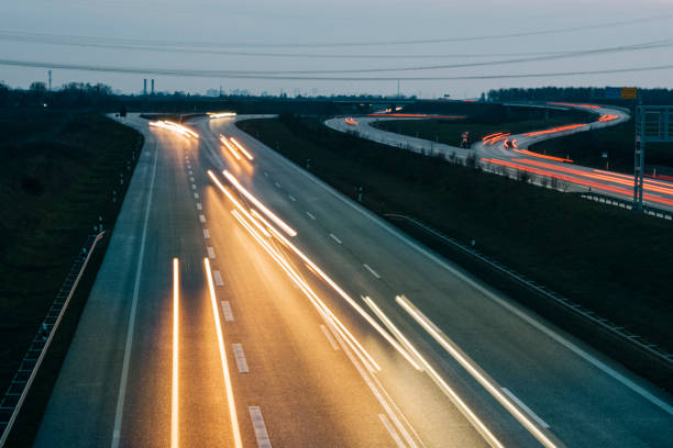istock Light tracks of cars on Highway, Highway Intersection A 11 1289862098