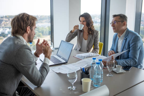 istock Business people sitting at the conference table 1289863072
