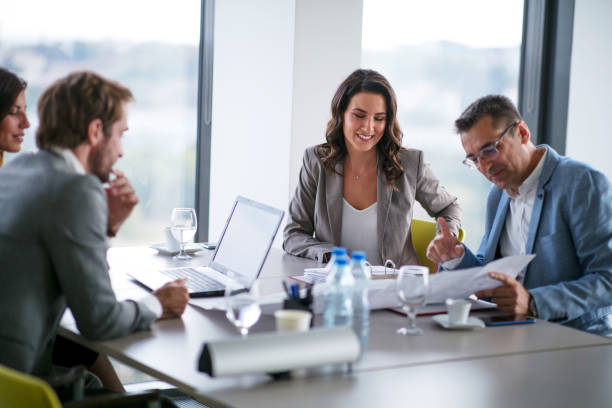 istock Businessman explaining the project and holding open sheet 1289863273