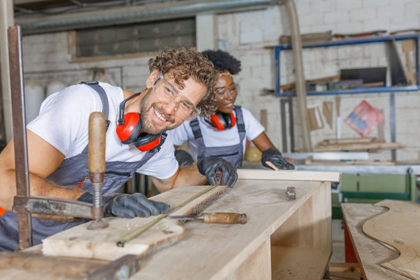 istock A Carpentry Workers are Measuring a Wooden Plank with a Measure Tape in a Workshop. 1289864424