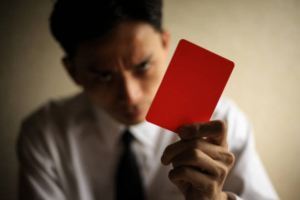 istock Male employee issuing a red card 1289864463