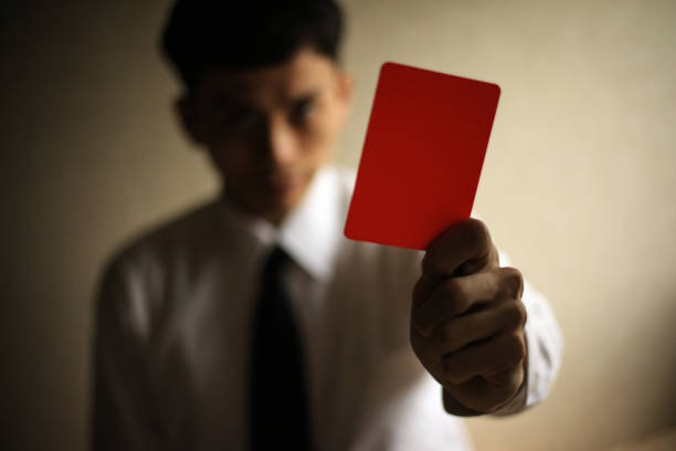 istock Male employee issuing a red card 1289864553