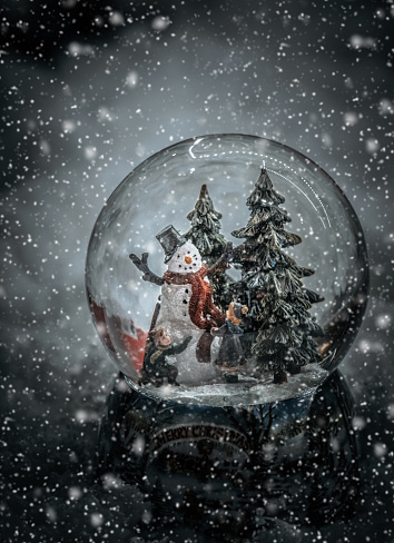 Christmas glass ball with snowman and children
