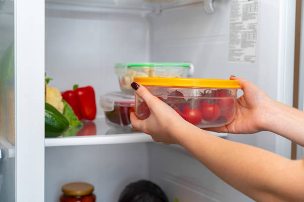 istock Female hands taking storage box with food from a fridge 1289865593