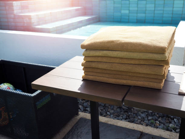 istock Pile of clean folded towels beside the pool. 1289865883