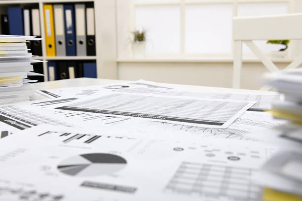 istock business concept - businessman's working table close view and office interior, financial reports and other office supplies 1289866271