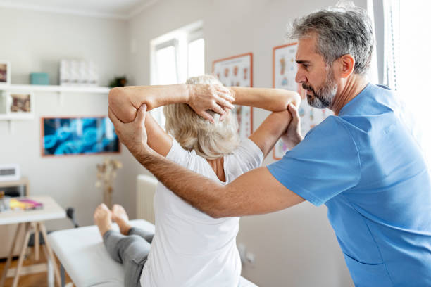Elderly Woman Having a Physiotherapy Session Modern rehabilitation physiotherapy chiropractors stock pictures, royalty-free photos & images