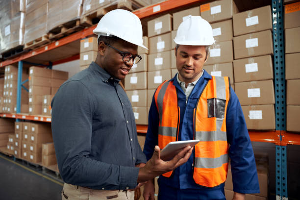 istock Multi ethnic factory engineers checking digital tablet at factory warehouse 1289868807