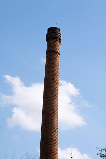 Old tall brick chimney in sky in Dresden