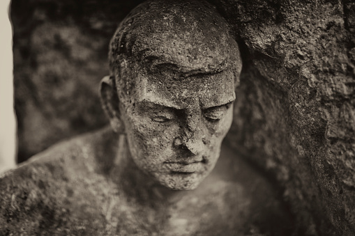 Stone ancient woman antiquated ruins statue in green park, botanical garden, Askania-Nova, Kherson region, Ukraine.