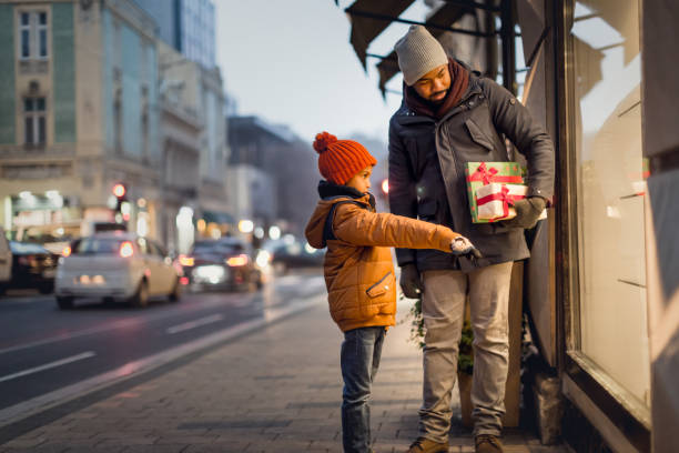 istock Young man with his son in Christmas shopping 1289872125