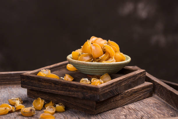 Dried abalone in plate on wood background.