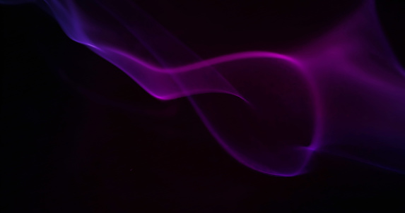 Set close-up of floating purple smoke. isolated on a black background