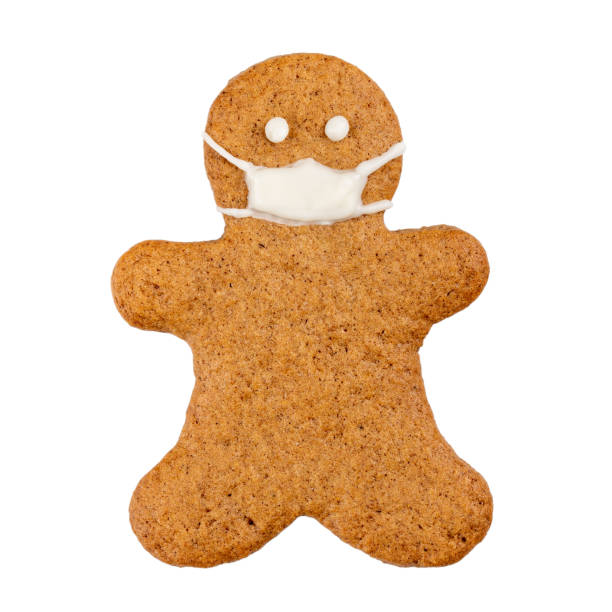 istock Gingerbread man in protective face mask isolated on white background. Christmas pandemic. 1289878801