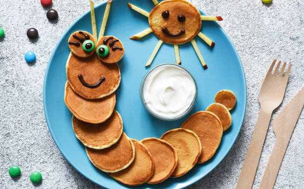 istock Funny caterpillar with eyes. Pancake caterpillar, funny kids breakfast. 1289879594