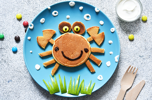 Funny crab on a plate. Pancake crab, children's breakfast. Lunch to school.