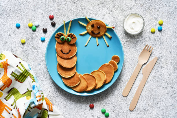 istock Funny caterpillar with eyes. Pancake caterpillar, funny kids breakfast. 1289879651