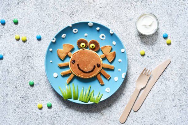 istock Funny crab on a plate. Pancake crab, children's breakfast. Lunch to school. 1289879656