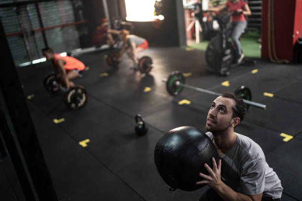istock Young man training with ball in gym 1289879750