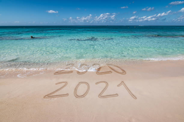 istock New year 2021 written on the beach. 1289880457