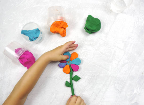 istock multi-colored plasticine for children's creativity and crafts, child made a flower 1289880532